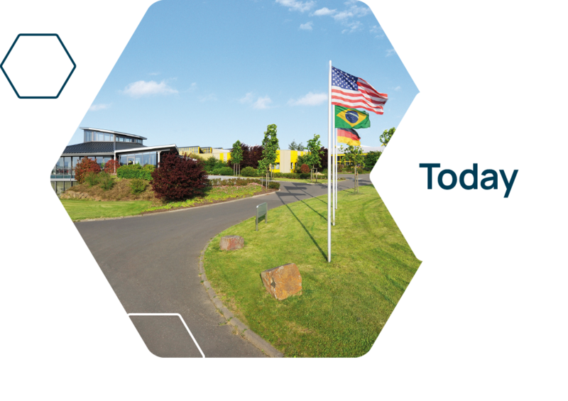 Exterior view of the company heinrichs drehteile with the three national flags.